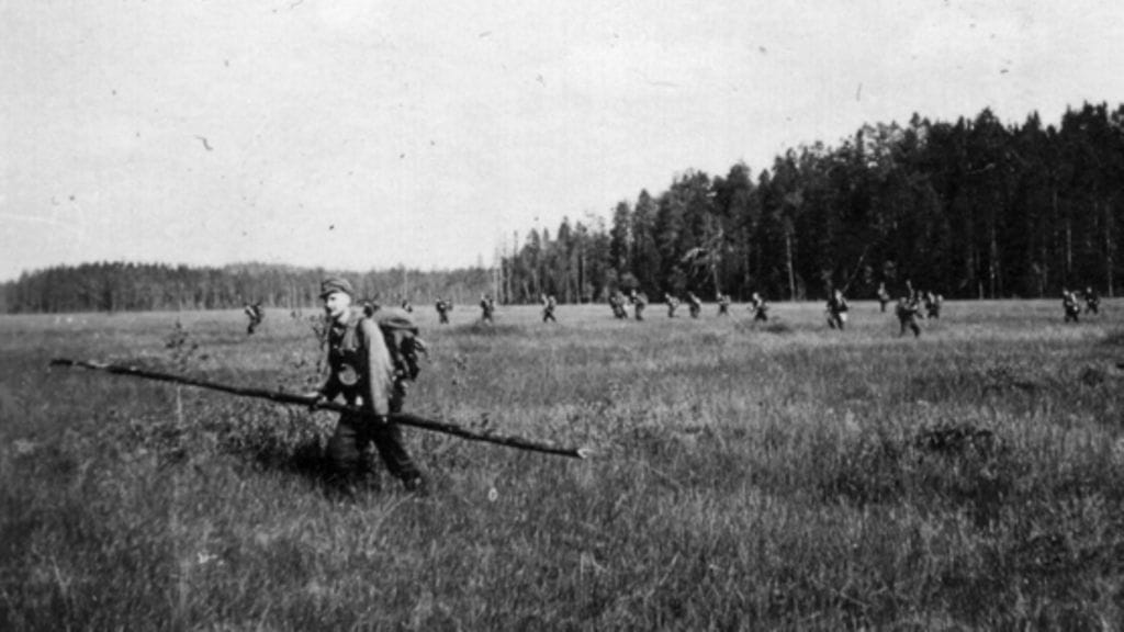 Partiomiehet ylittämässä suota.